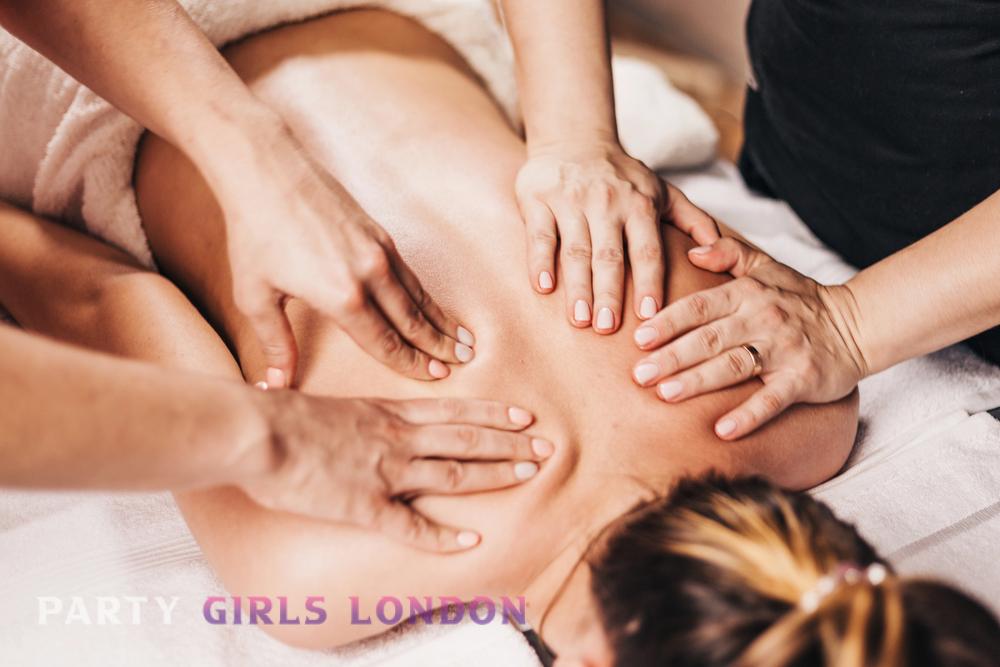 multiple hands giving a relaxing back massage to a woman lying on a spa table, symbolising coordination and relaxation in multi-hand treatments