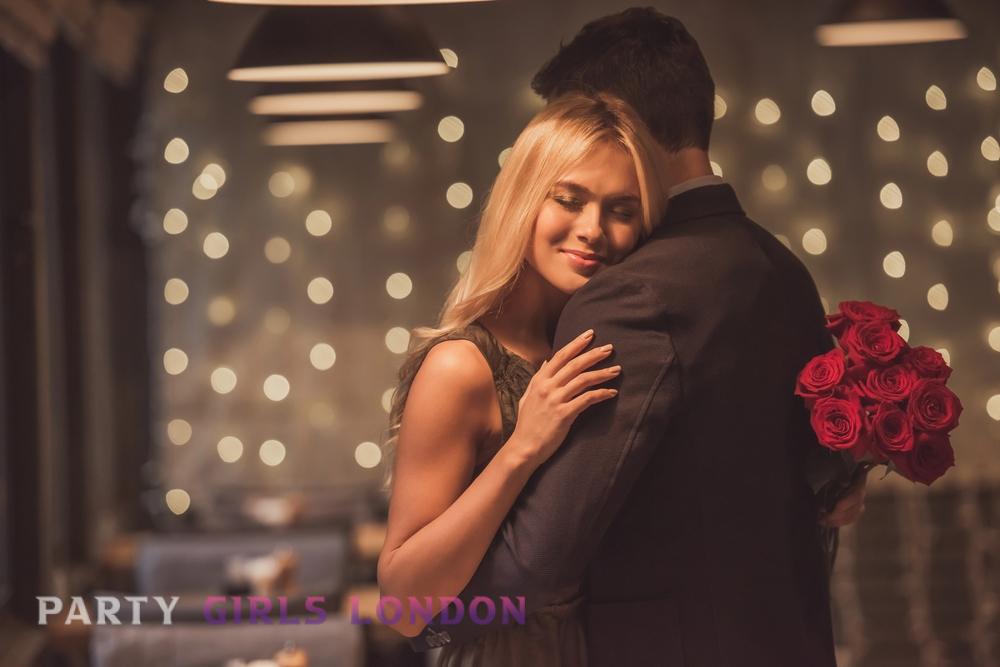 Romantic couple embracing in a dimly lit bar with a bouquet of roses, capturing the charm of Kensington's best bars and pubs.